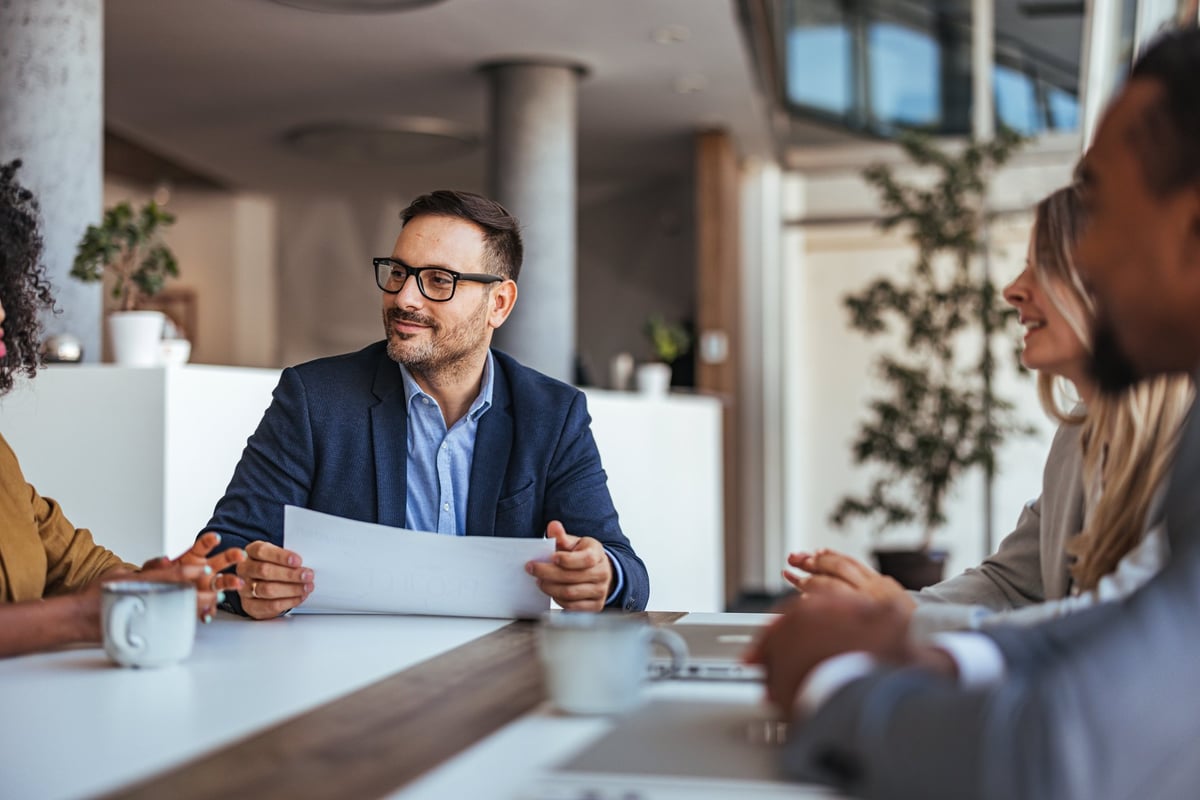 A diverse team engages in a productive business meeting in a modern office, enhanced by teamwork and collaboration