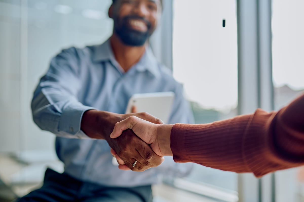 Two business professionals shaking hands, symbolizing successful partnership and collaboration